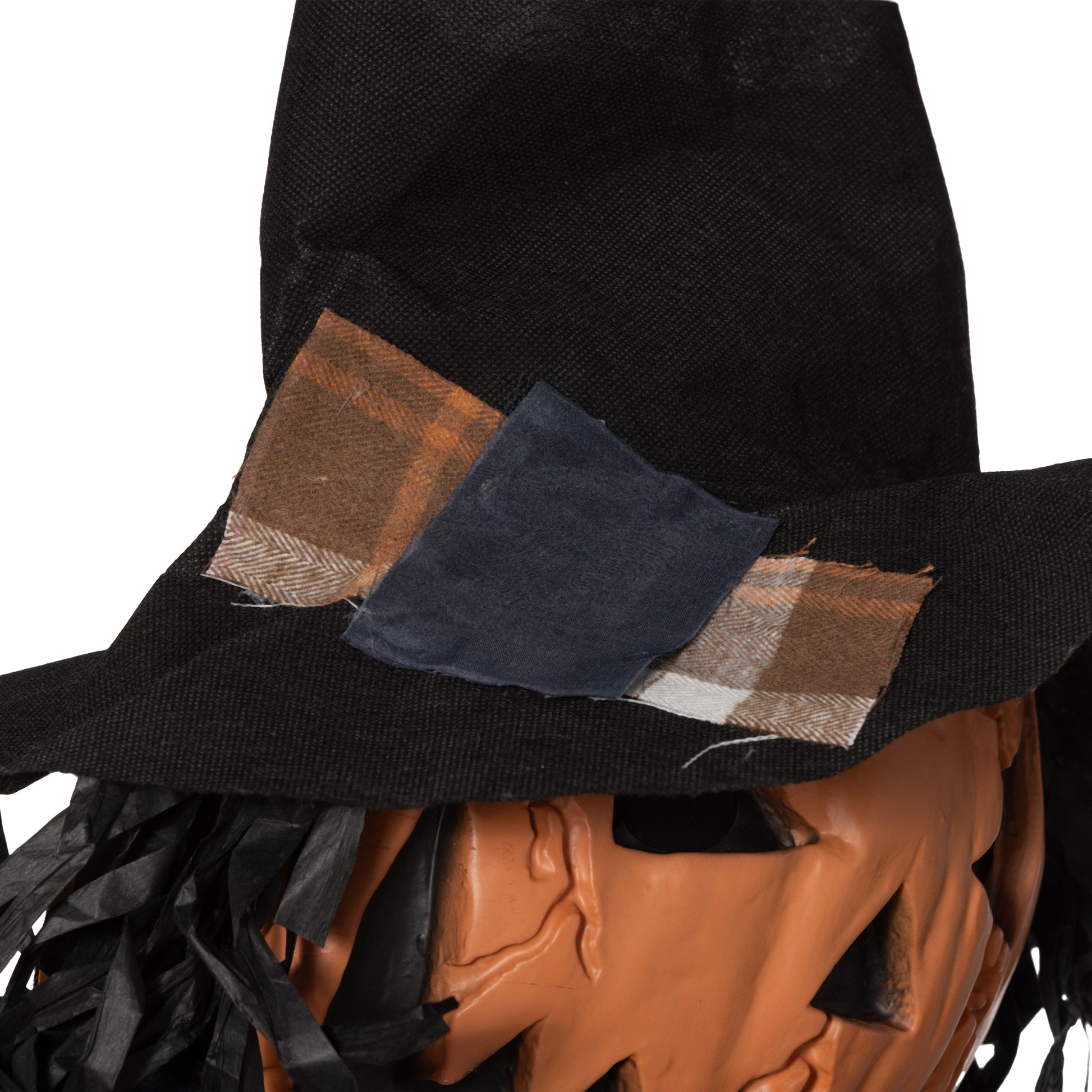 Scarecrow decoration with orange jackolantern face black hat with plaid patches and black fringe hair