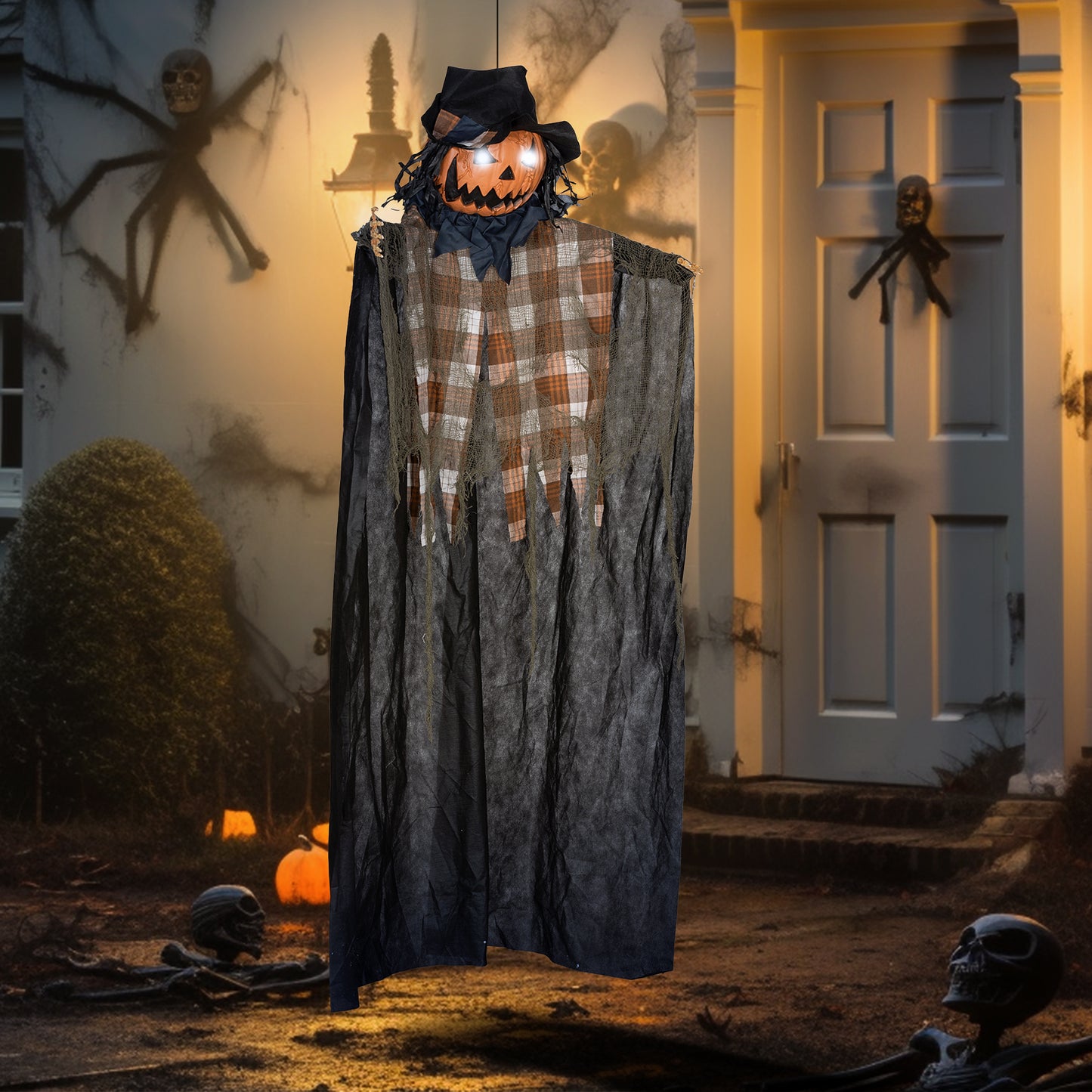 Scary hanging Halloween scarecrow decoration with pumpkin head and plaid torso