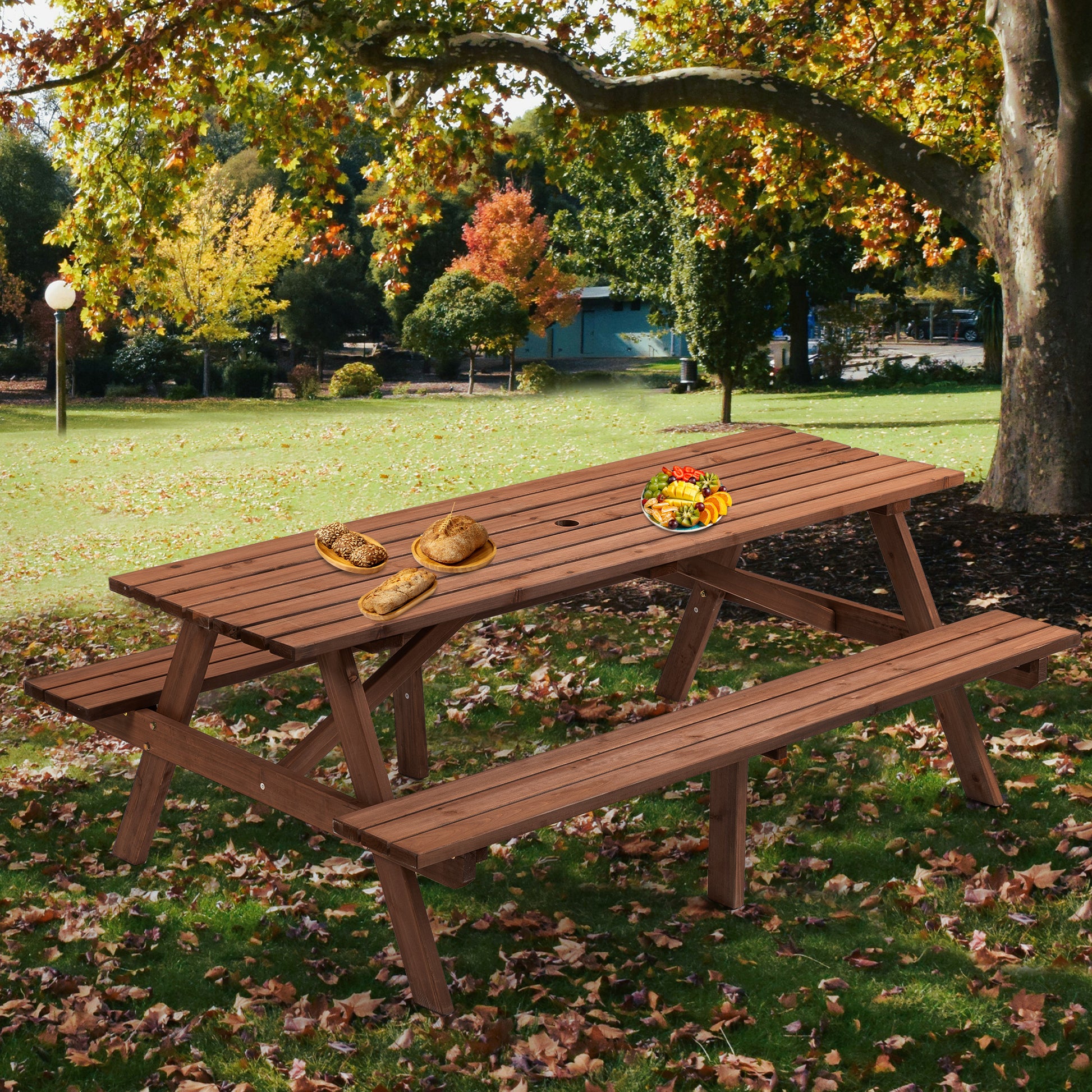 Wooden picnic table with attached benches set up in an autumn park setting