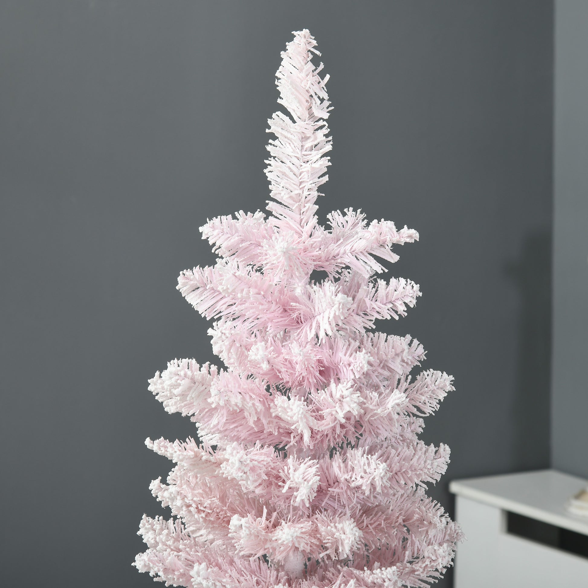 Closeup of a fluffy pink artificial Christmas tree with frosted tips