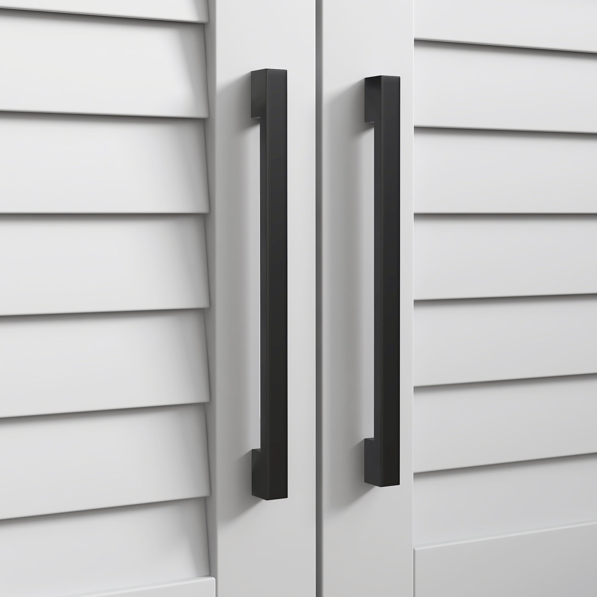 Two modern black cabinet pulls on a white louvered door panel
