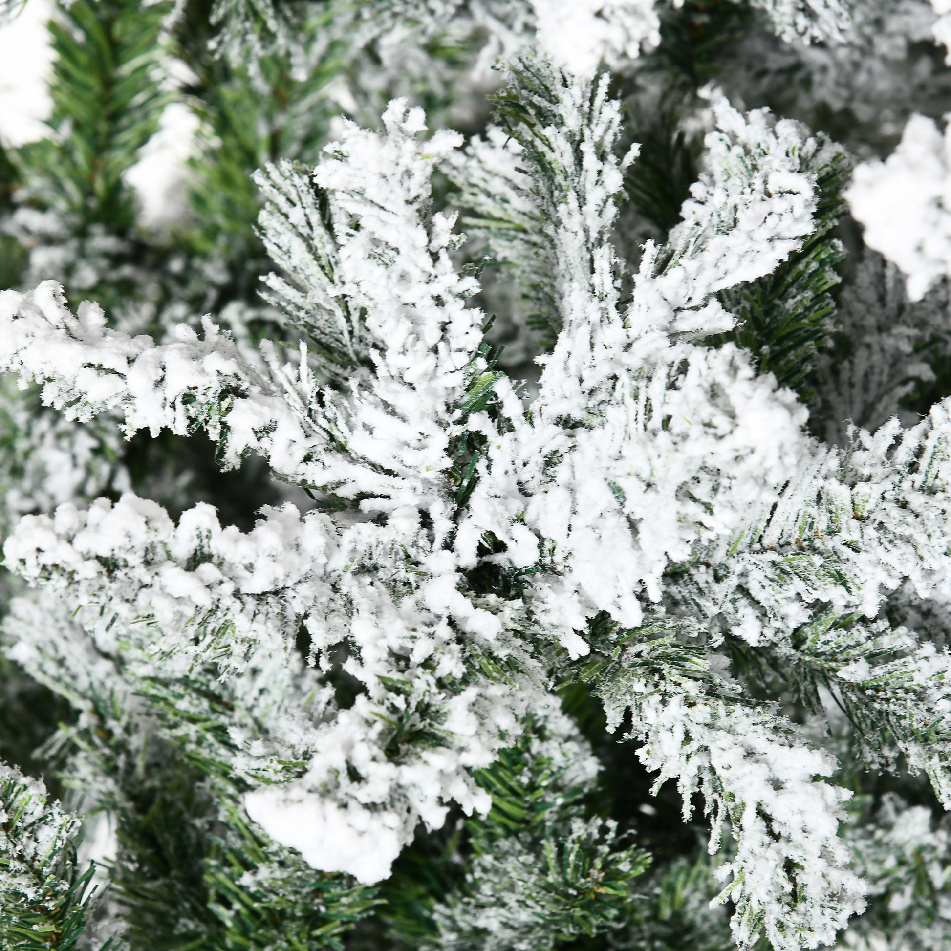 Close up of flocked pine branches with realistic snow effect for Christmas decor