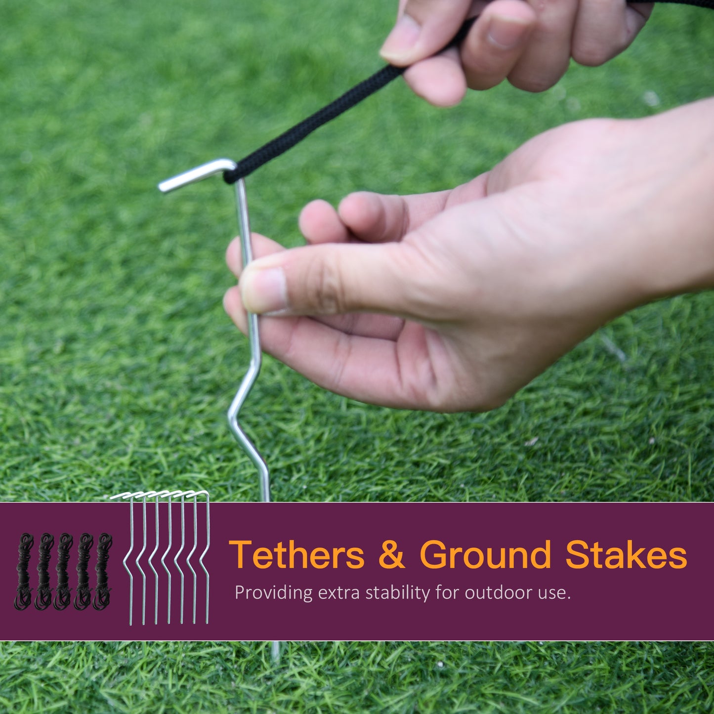 Silver metal ground stakes with black rope tethers securing camping gear outdoors