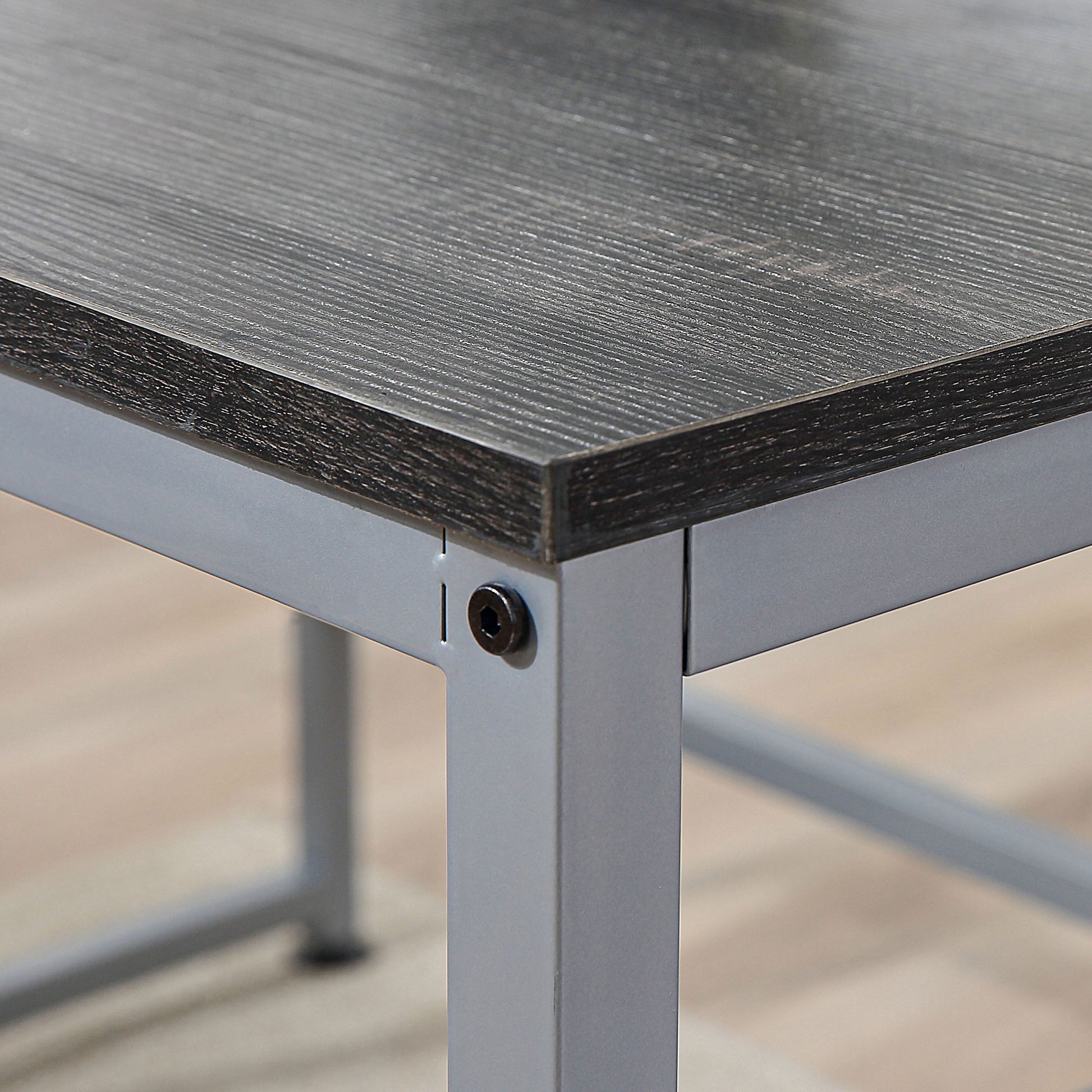 Dark wood grain textured desktop with silver metal frame leg