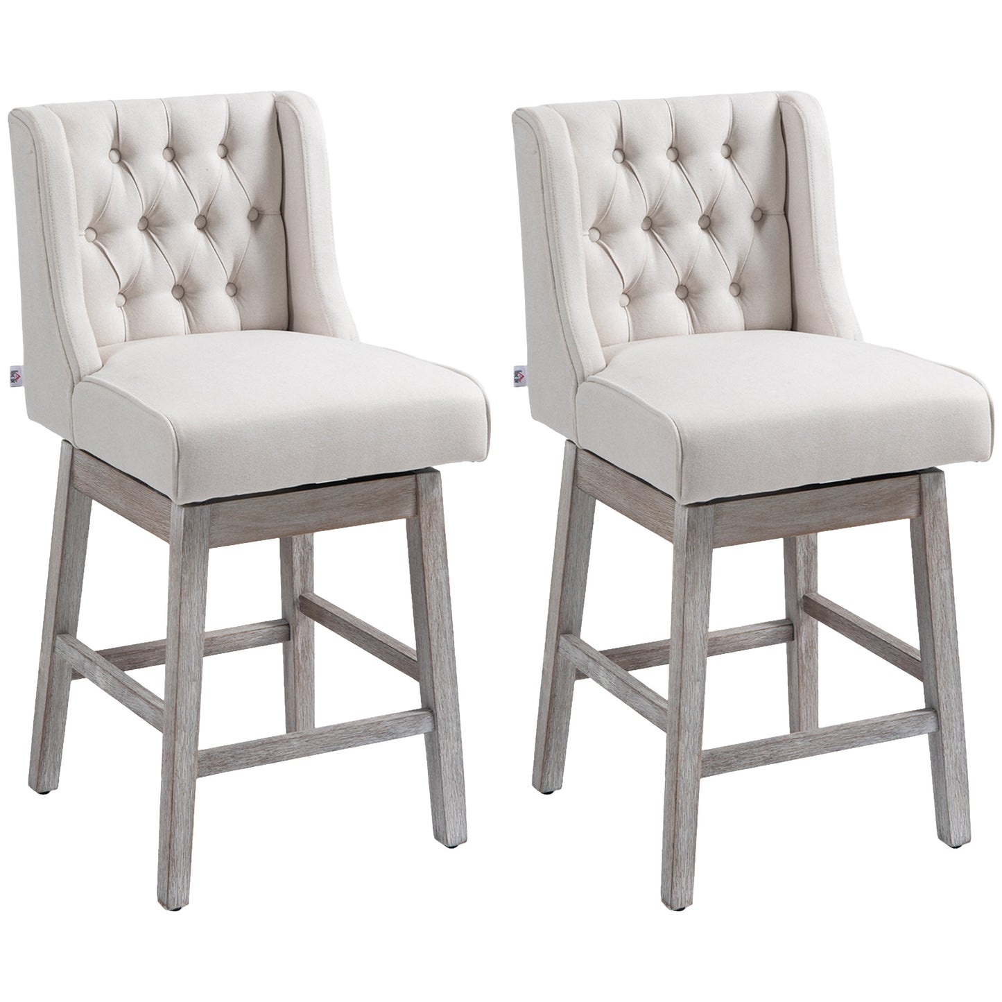 Two beige upholstered swivel bar stools with tufted backs and distressed wood legs