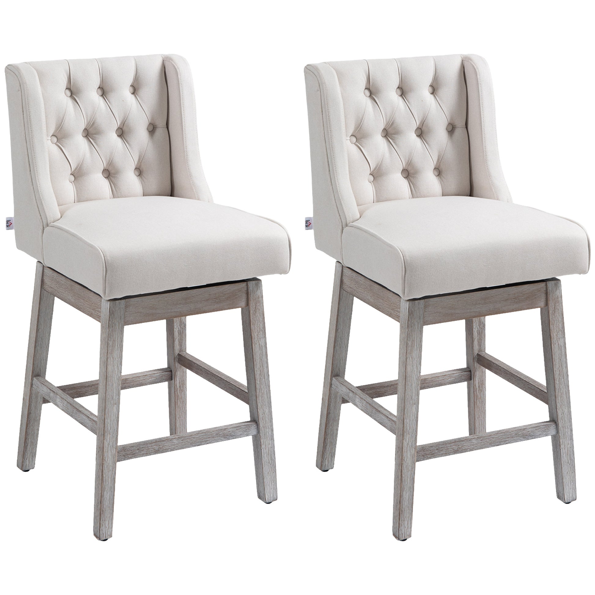 Two beige upholstered swivel bar stools with tufted backs and distressed wood legs