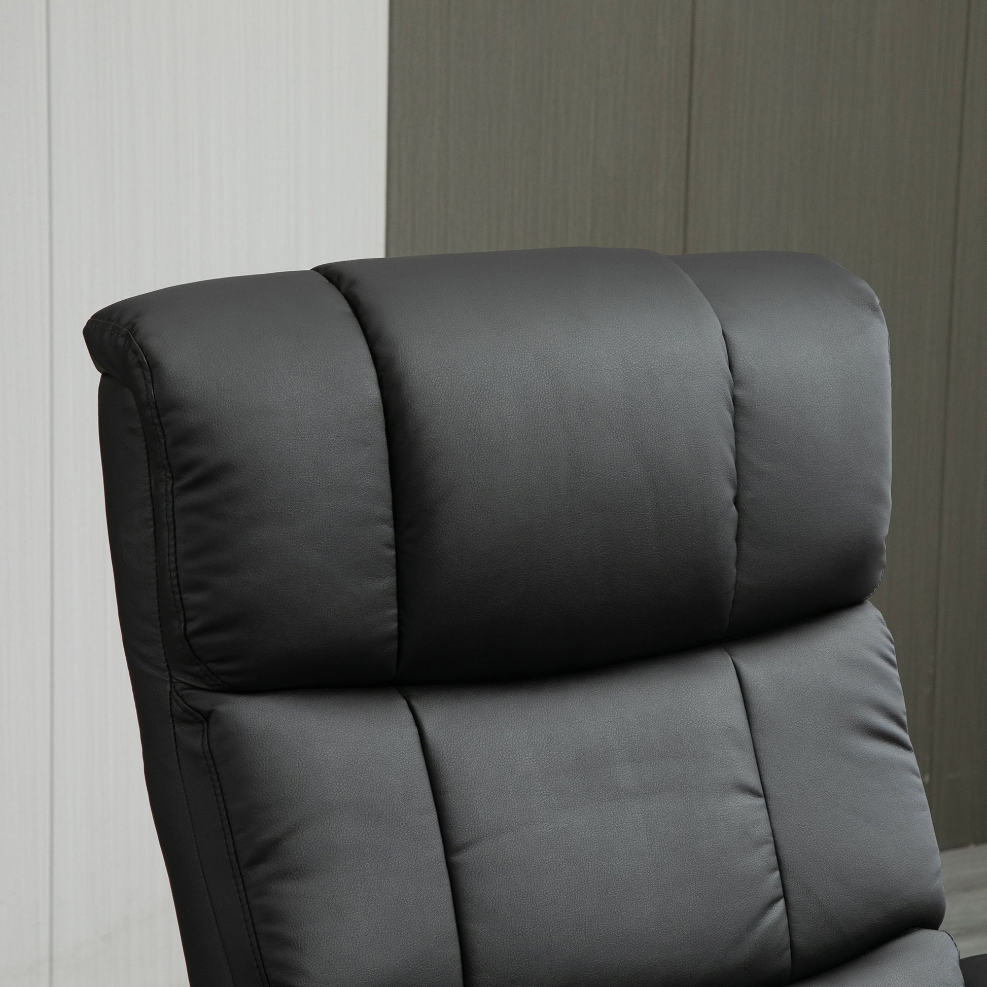Padded black executive office chair headrest with quilted detail for comfort and support