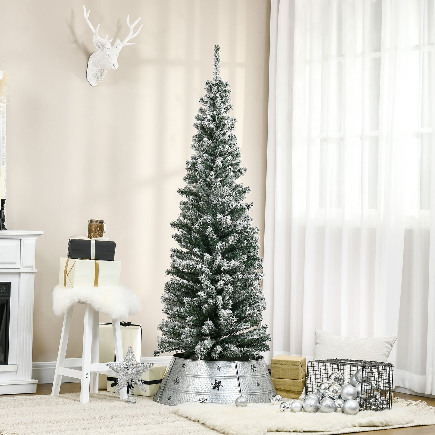 Flocked artificial Christmas tree with snowdusted branches and a galvanized metal tree collar