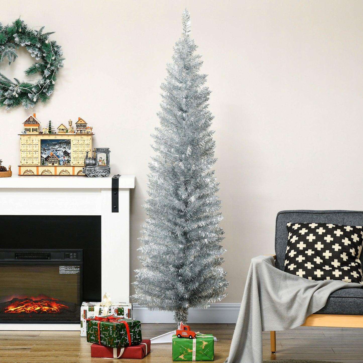 Tall slender silver tinsel artificial christmas tree with realistic branches