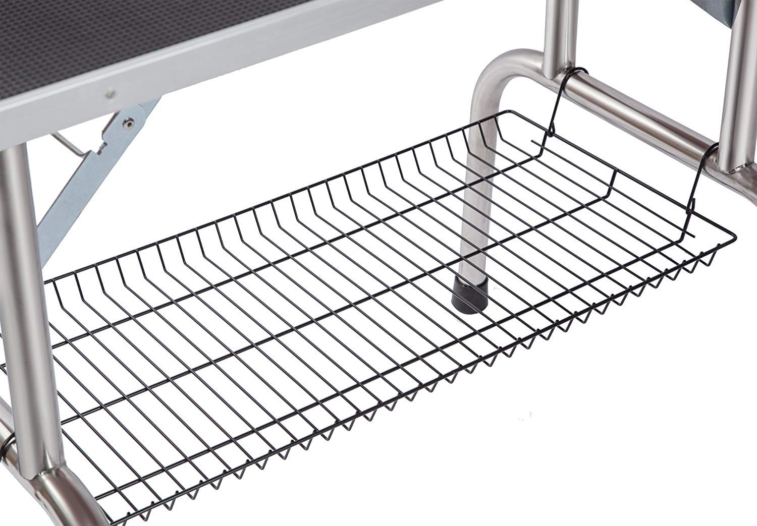 Black wire storage basket hanging from stainless steel grooming table leg