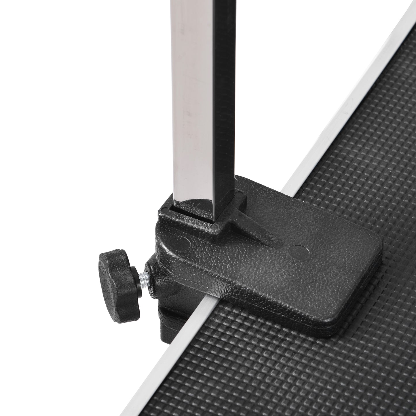 Adjustable clamp secures metal leg to textured grooming table surface