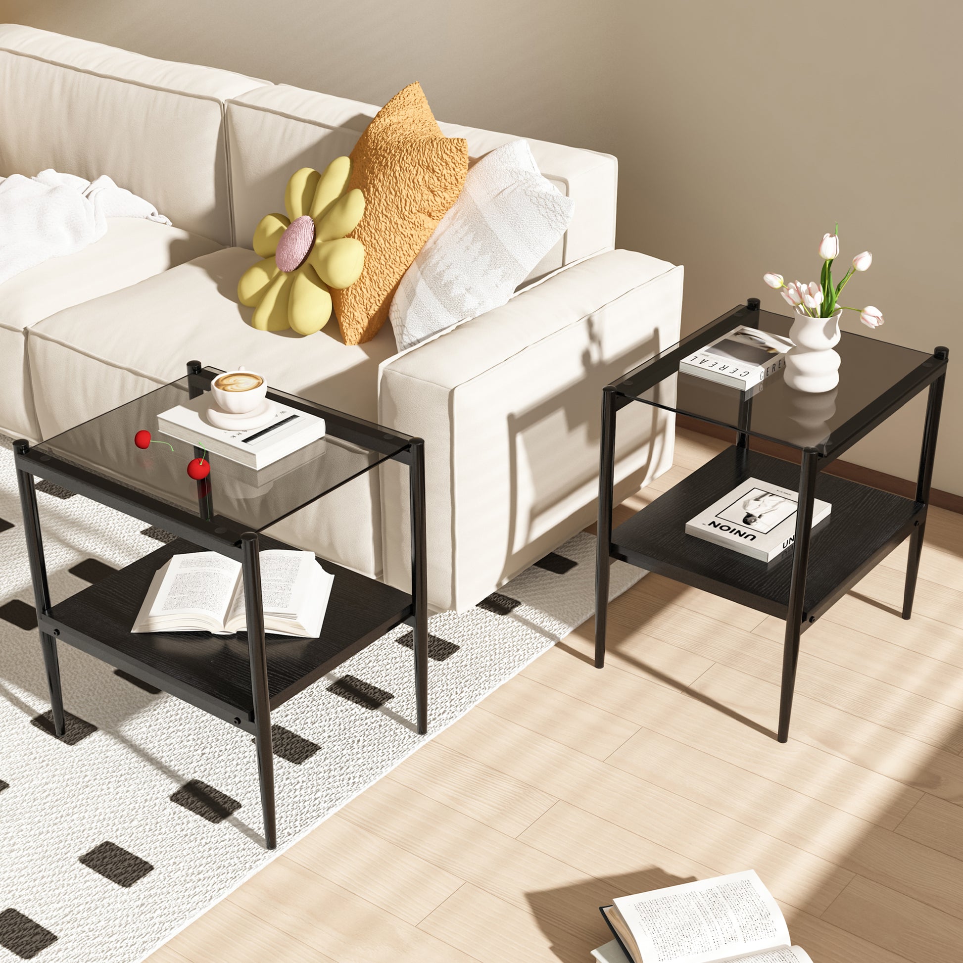 Black metal end table with glass top holding a book and coffee