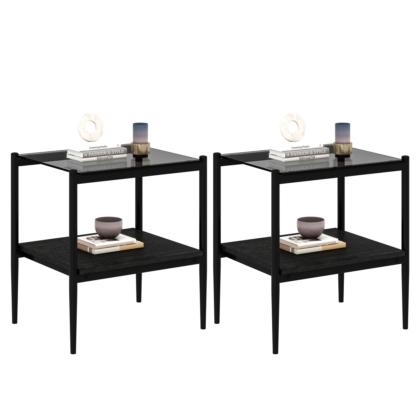 Two modern black end tables with glass tops and open lower shelves styled with books and decor
