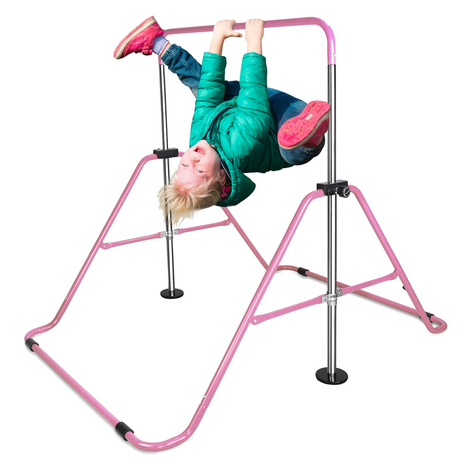 Child hanging upside down on a pink gymnastics bar wearing a green jacket and jeans