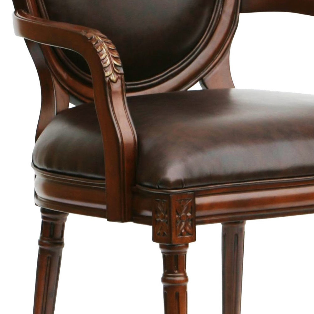 Detailed view of dark brown leather armchair with carved wooden arms and legs