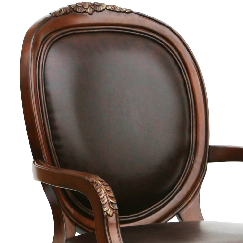 Dark brown leather armchair with ornate wood trim and leaf carvings on arms