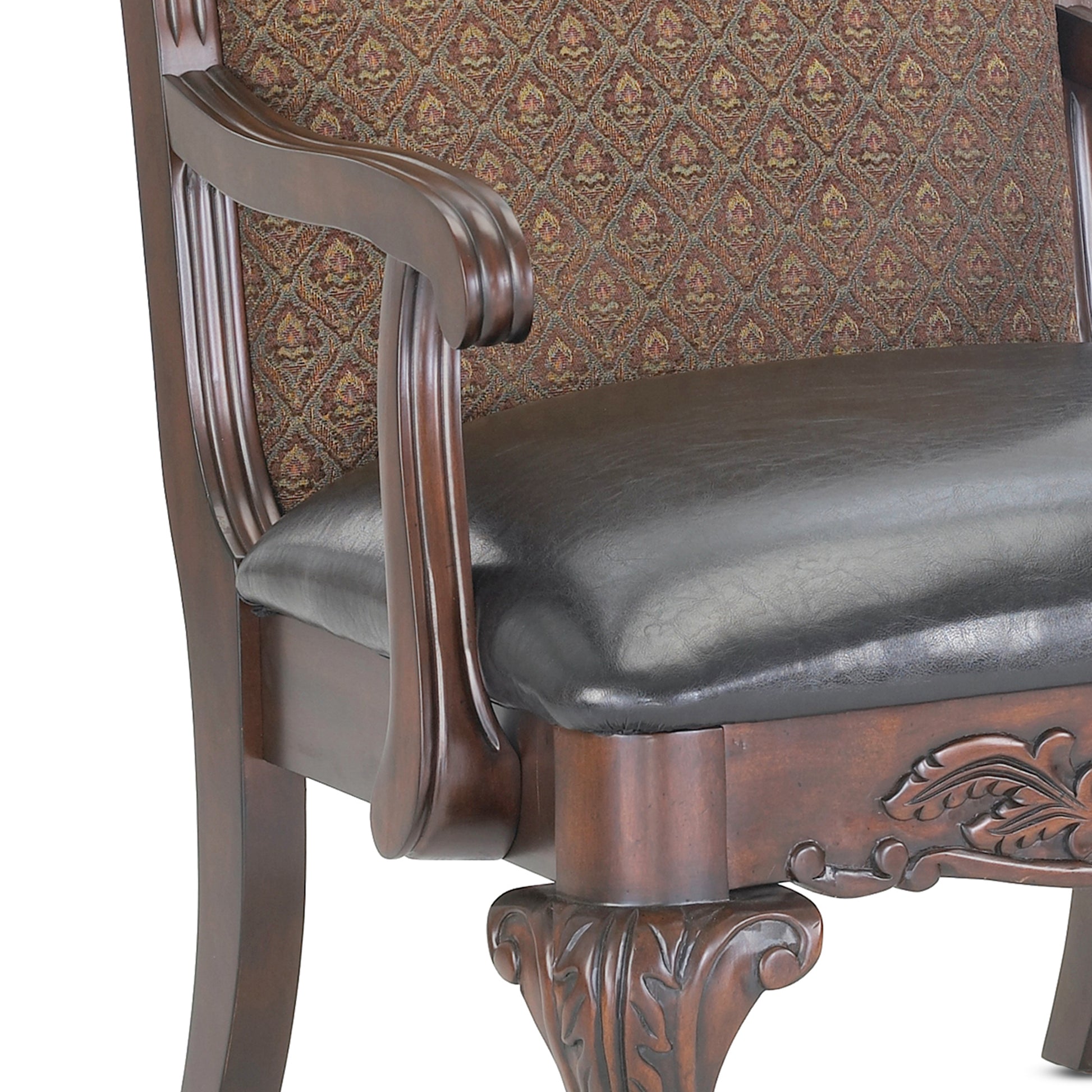 Dark brown leather armchair with ornate carved wood details and patterned fabric upholstery
