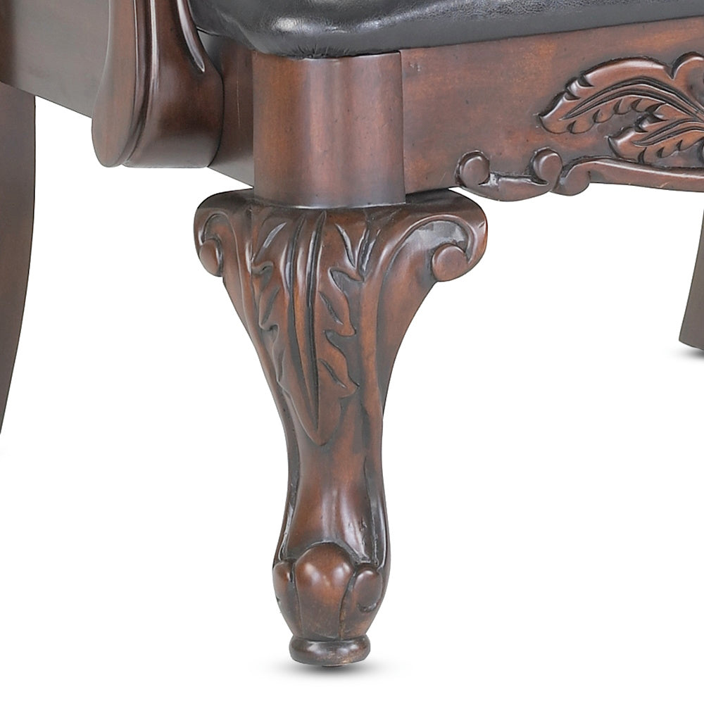 Ornate carved dark wood cabriole leg with acanthus leaf motif for a vintage armchair