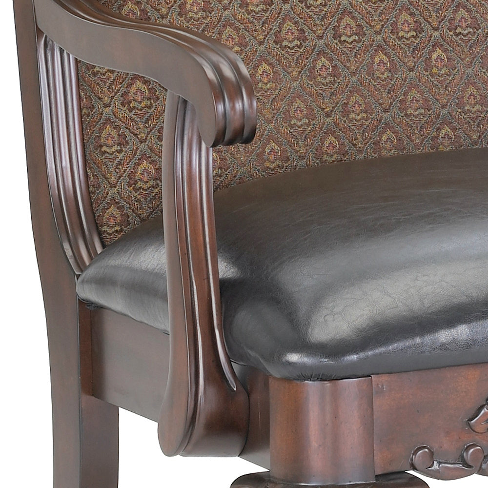 Close up of a dark brown leather executive chair with ornate patterned fabric upholstery and carved wooden armrests
