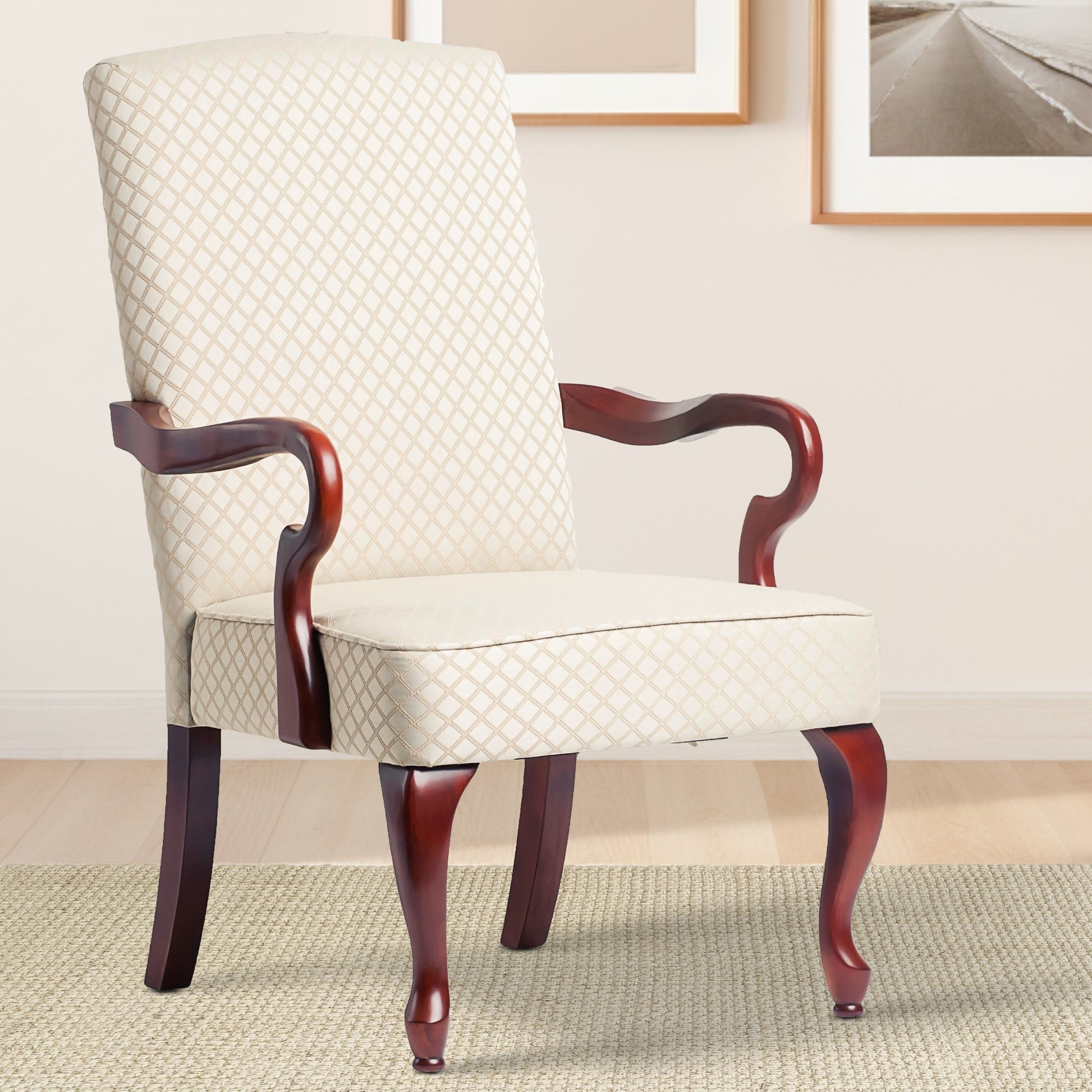 Ornate upholstered armchair in cream with diamond pattern and dark wood legs