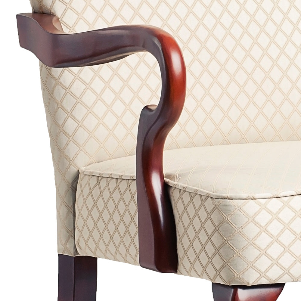 Cream diamondpatterned armchair with polished mahogany armrest