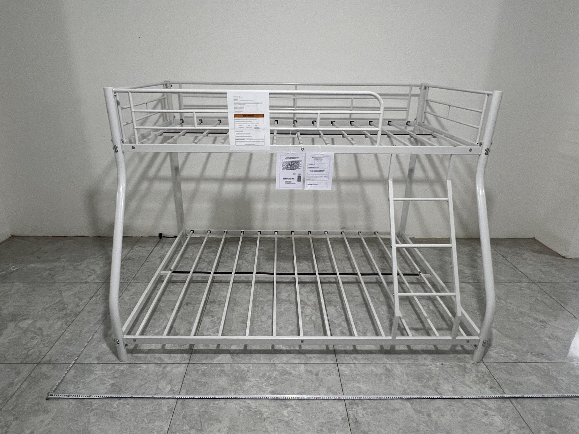 White metal twin over twin bunk bed with ladder and safety rails
