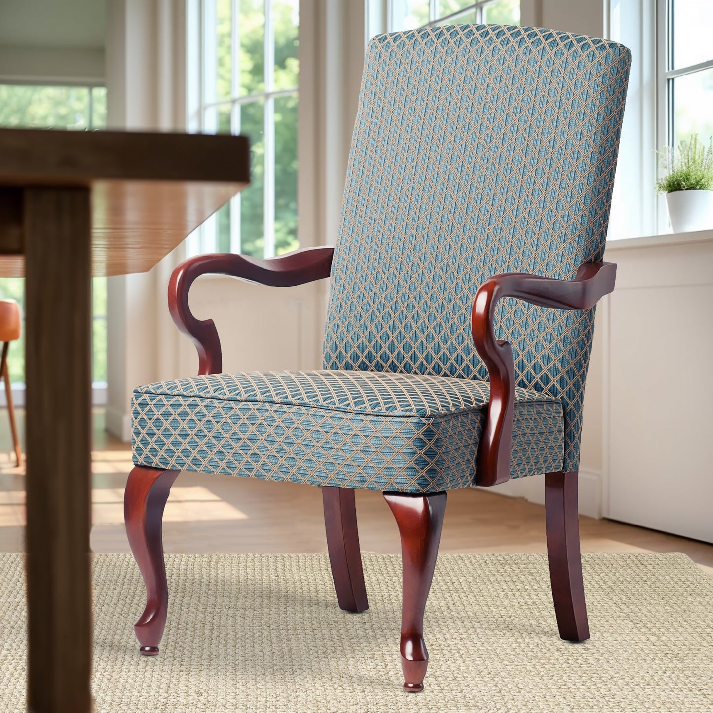 Upholstered dining chair with blue and beige diamond pattern fabric and dark wood arms