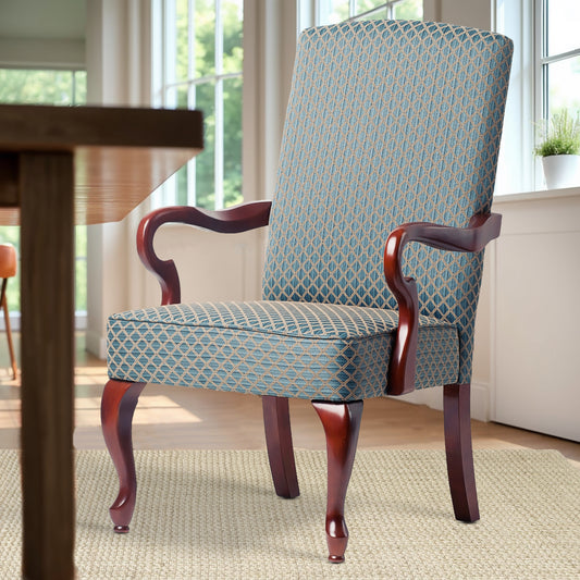 Upholstered dining chair with blue and beige diamond pattern fabric and dark wood arms