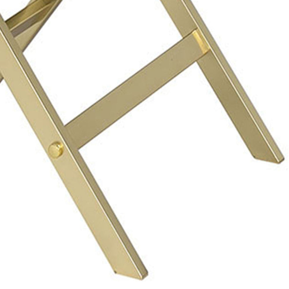 Closeup of polished brass folding chair legs showing modern design elements