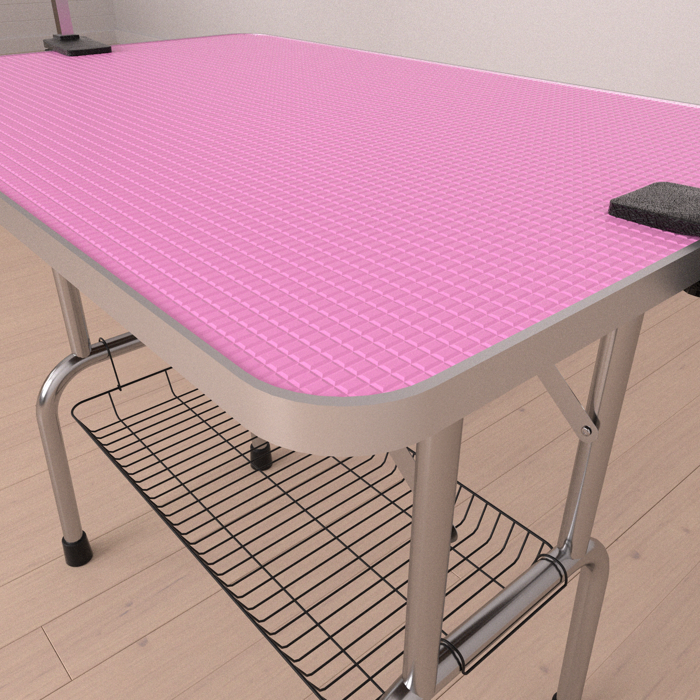 Pink grooming table with textured surface and metal legs featuring a storage basket below