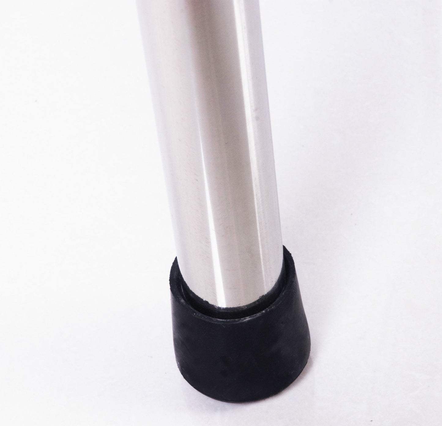 Sleek metal leg with a black rubber furniture foot for stability and floor protection
