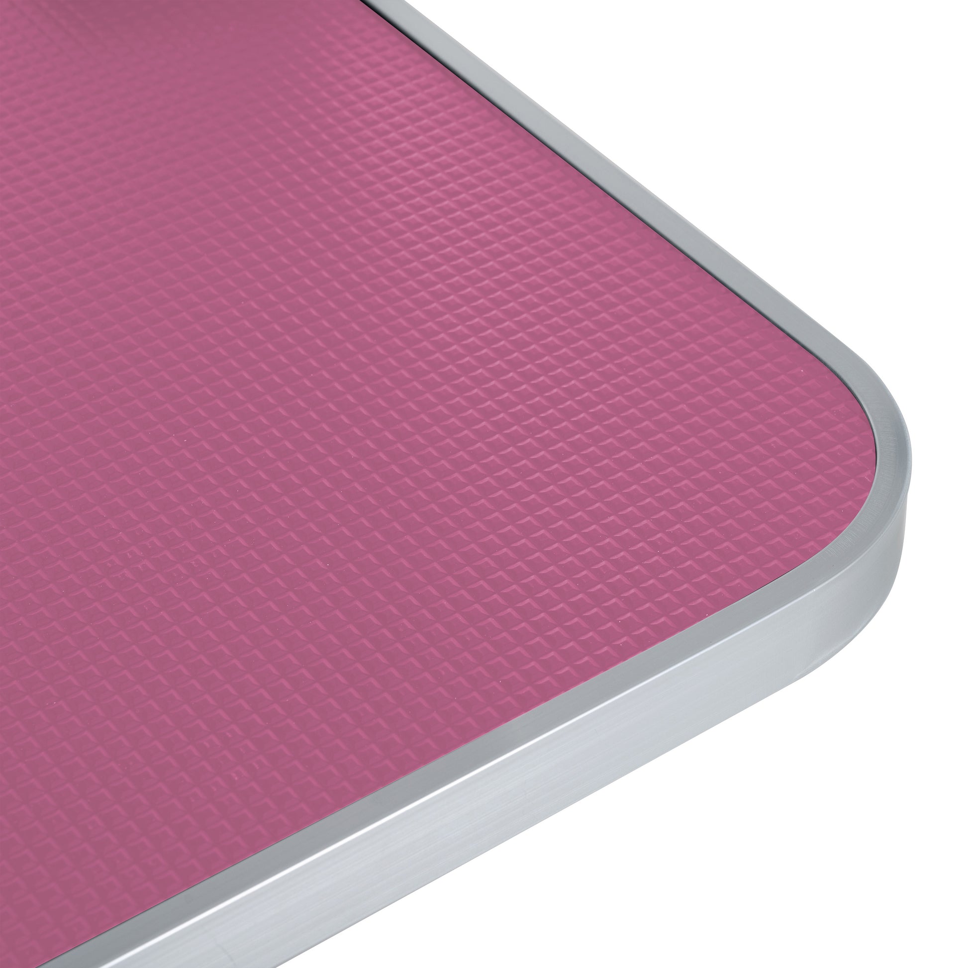 Textured pink dog grooming table surface with brushed aluminum edge