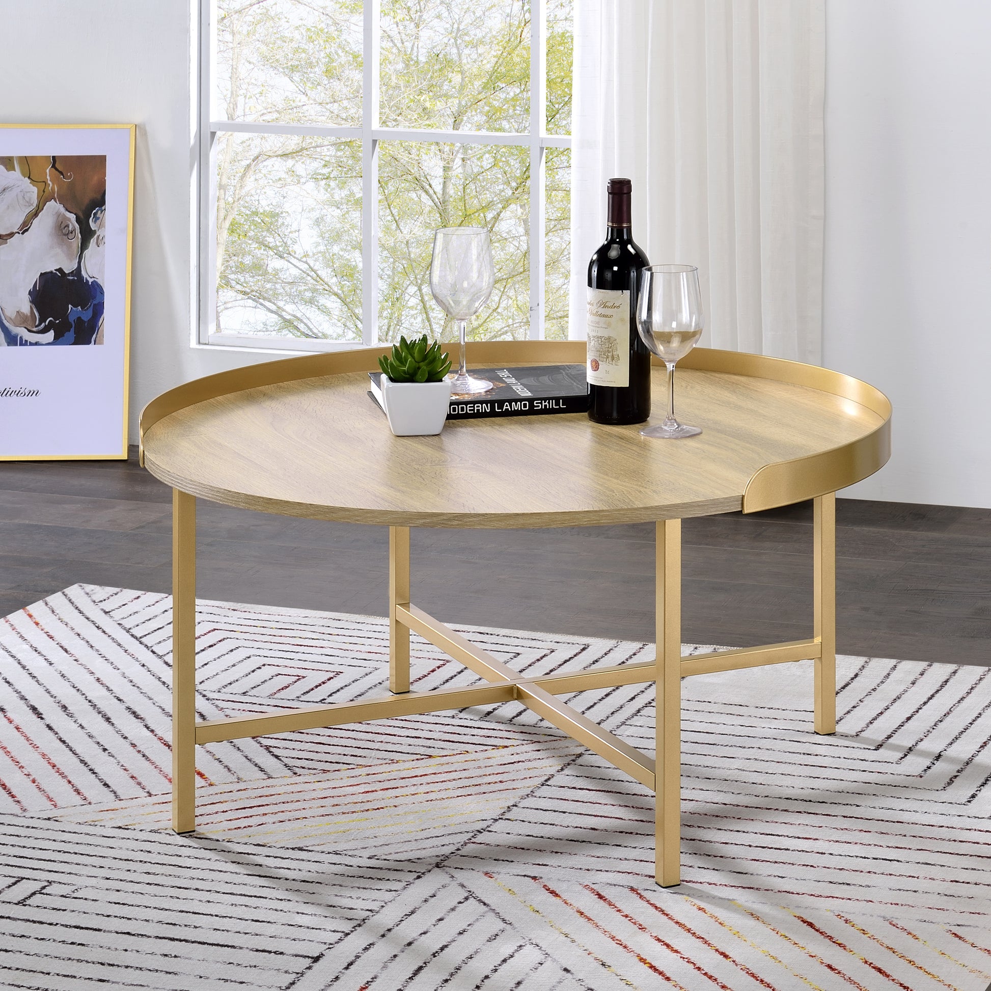 Round wood coffee table with gold metal legs and rim
