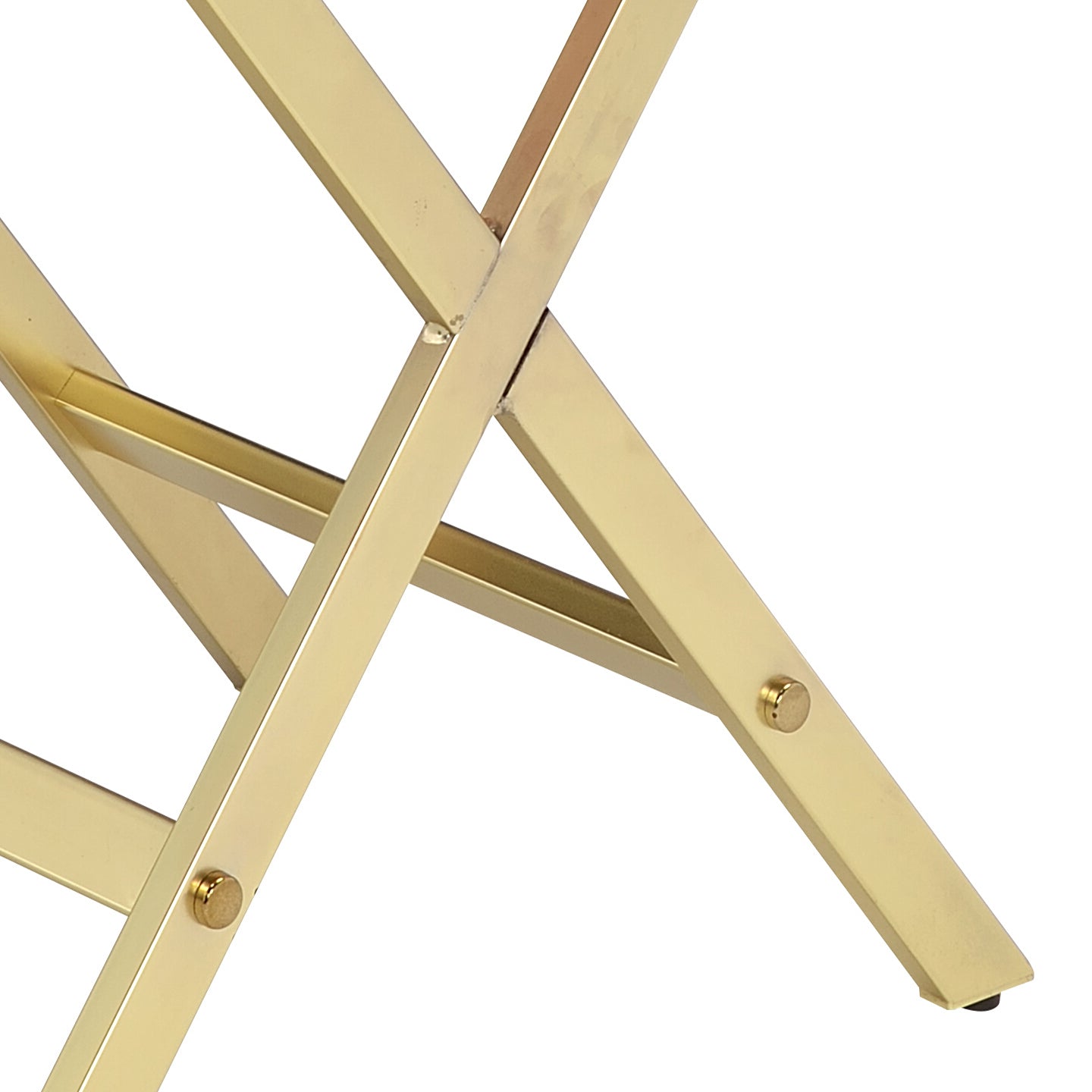 Detailed view of gold metal folding stool legs with riveted joint