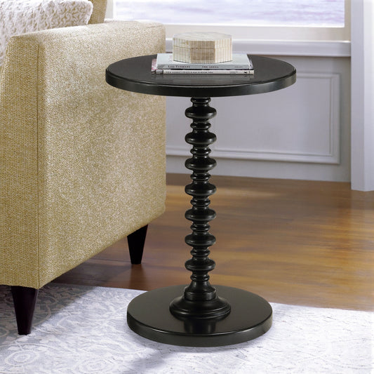 Black round accent table with ornate pedestal base ideal for side placement