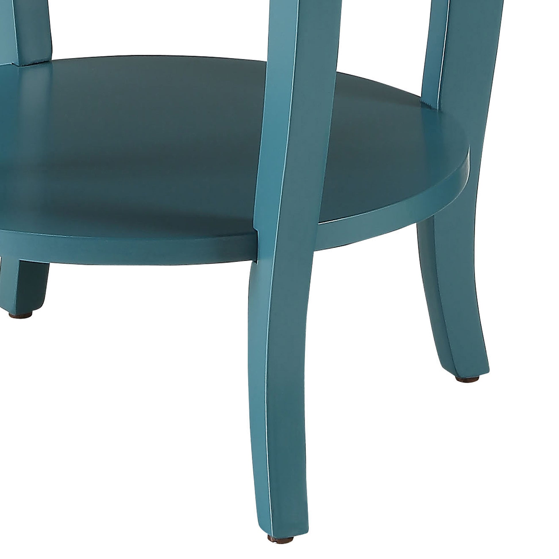 Closeup of a teal wooden side table shelf and carved legs with white trim detail