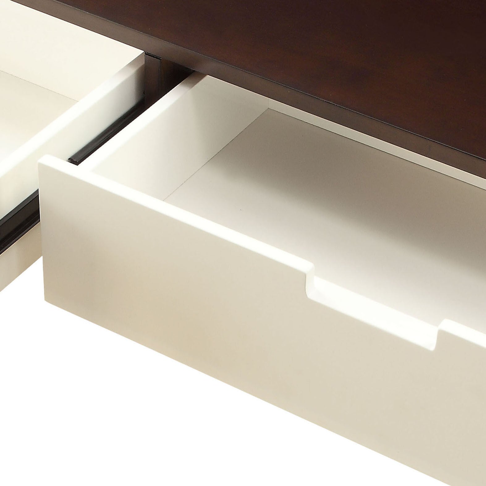Open dark brown wood desk drawer with white interior and smooth glide runners