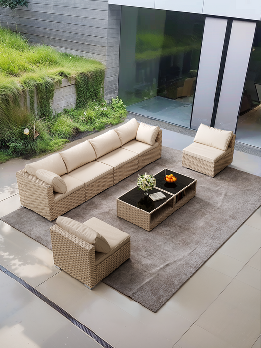 Beige rattan sectional sofa with plush cushions arranged in a modern patio setting