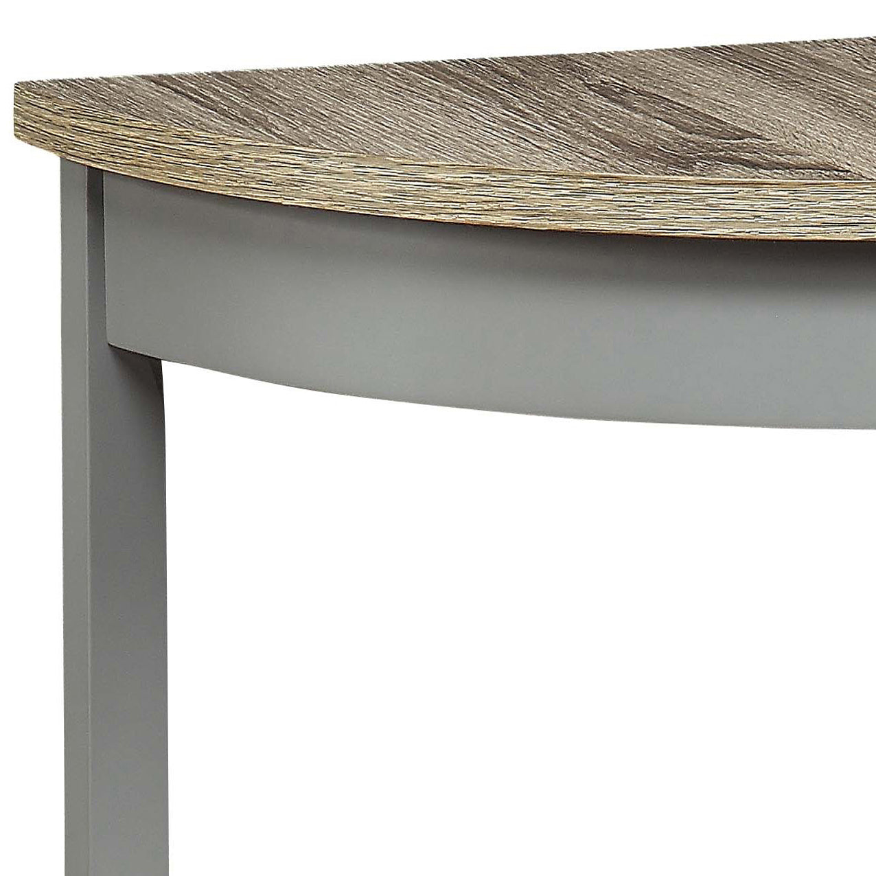 Closeup of a rustic oak veneer tabletop with a curved edge and a matte gray pedestal base