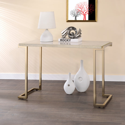 Modern gold metal console table with a textured stone top perfect for entryways