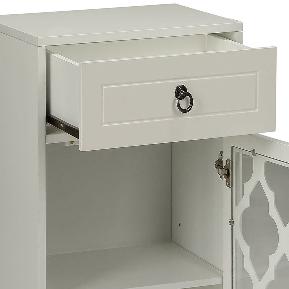 White bedside table with open drawer and decorative glass door accent