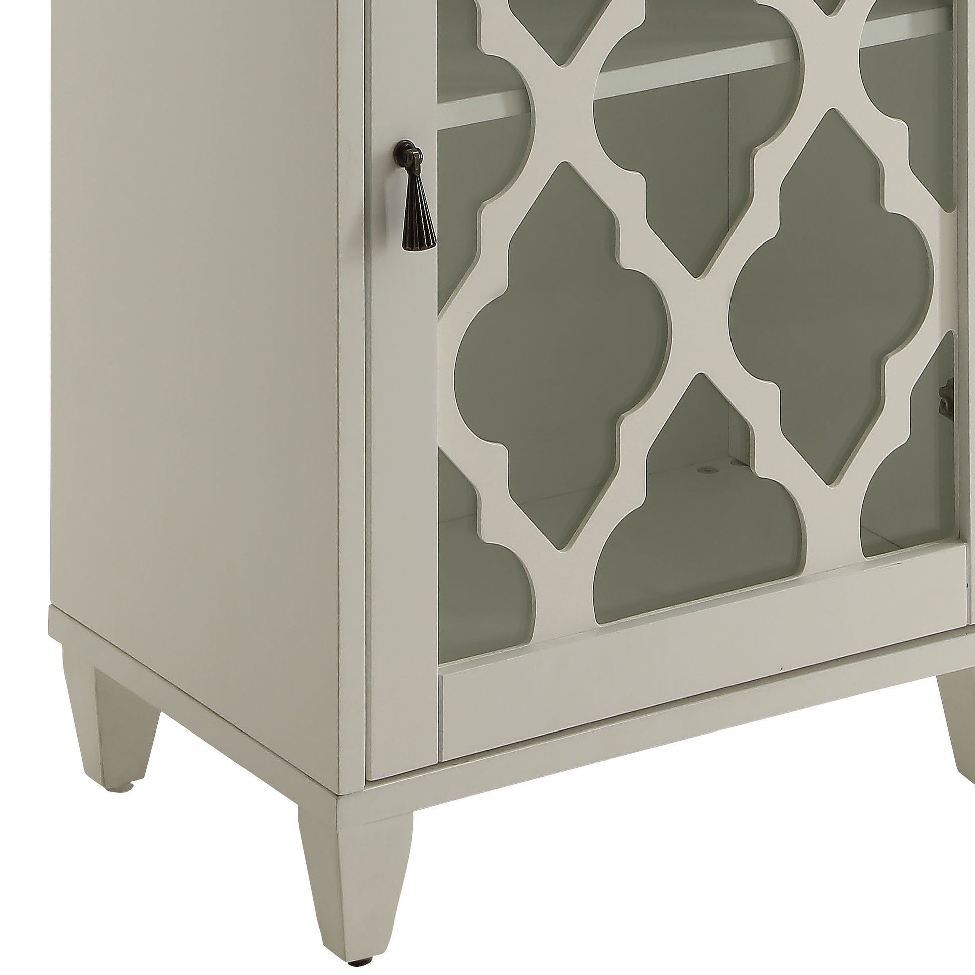 Light gray accent cabinet with decorative quatrefoil glass door and dark pull