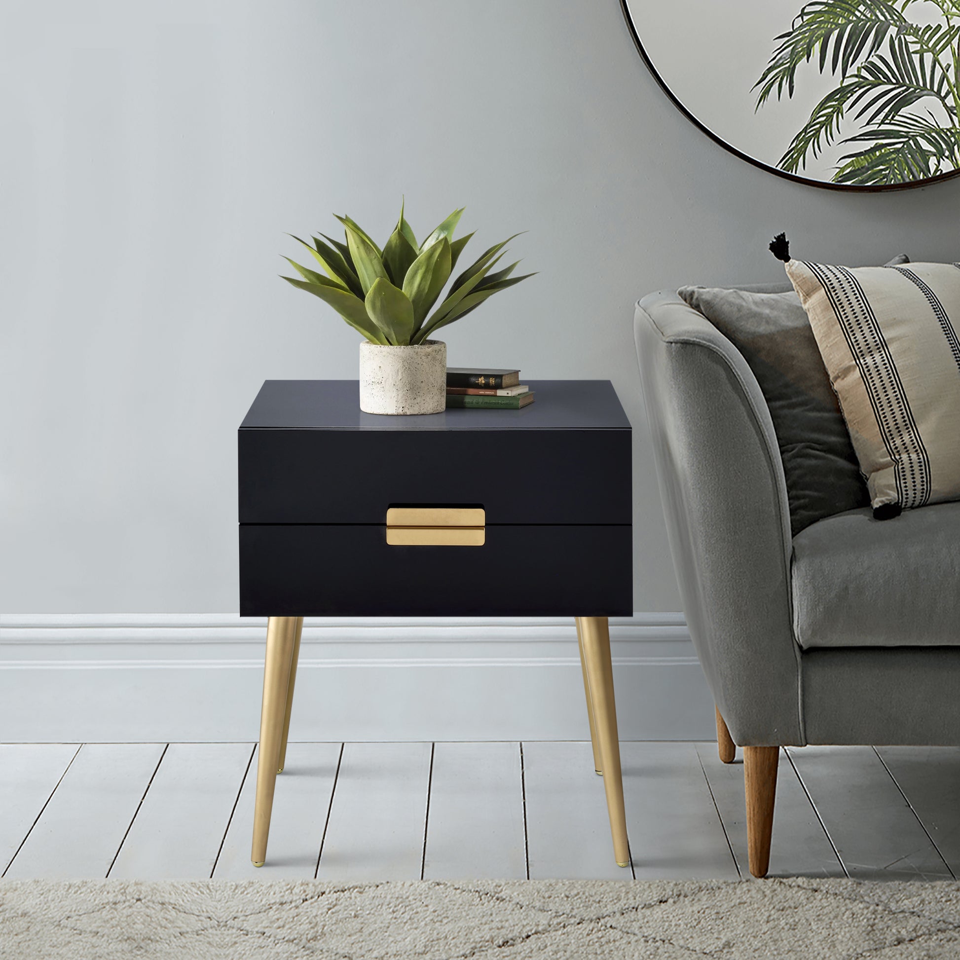 Sleek black bedside table with gold drawer pull and tapered gold legs