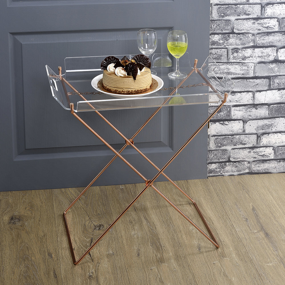 Acrylic serving tray with rose gold metal legs holding a cake and drinks