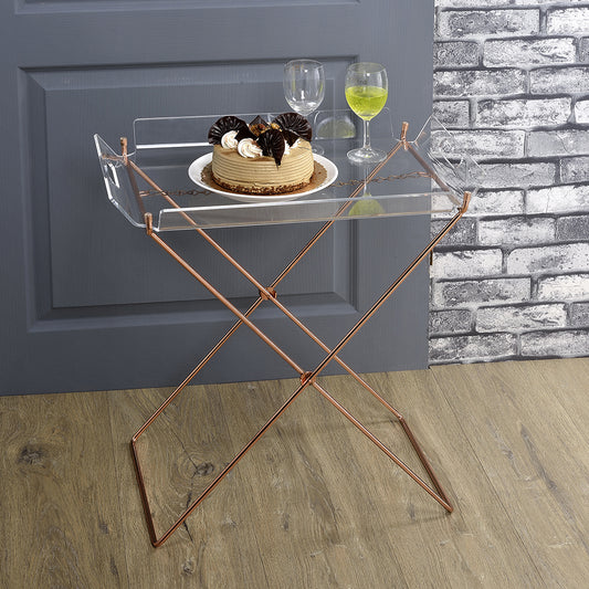 Acrylic serving tray with rose gold metal legs holding a cake and drinks