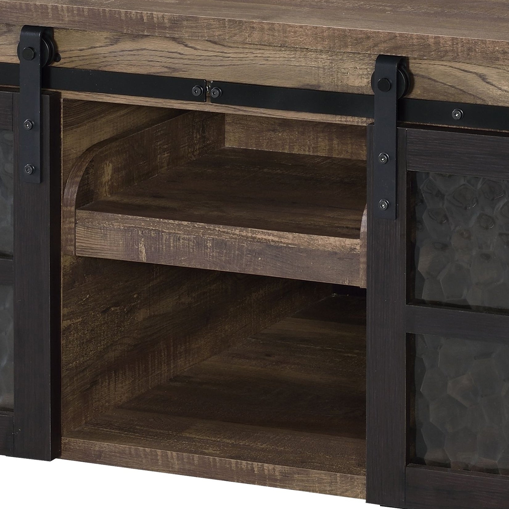 Rustic farmhouse TV stand with sliding barn doors and open shelving in distressed wood finish