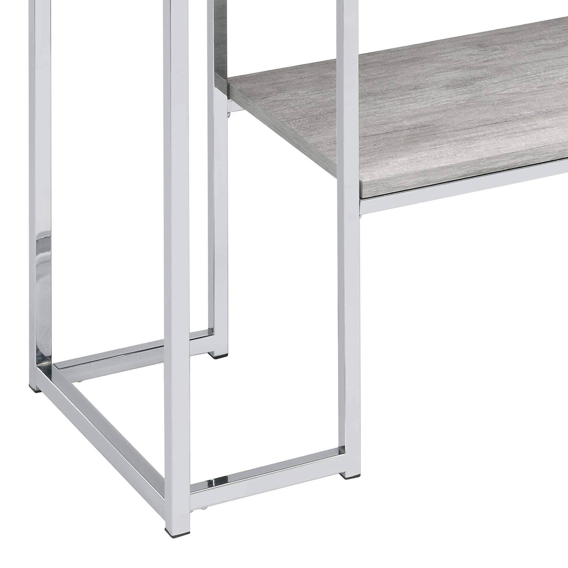 Chromeplated metal frame of a modern shelf unit with a grey wood grain shelf