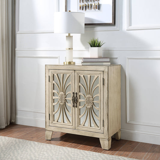 Cream carved wood accent cabinet with mirrored doors and decorative hardware