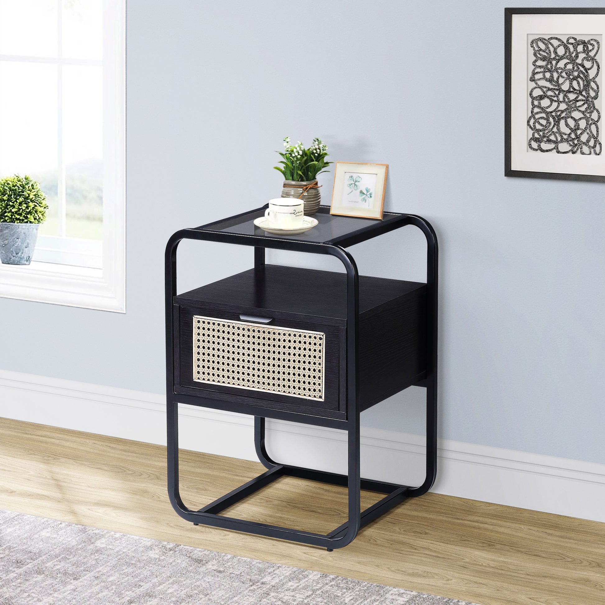 Black nightstand with woven cane drawer front and metal frame