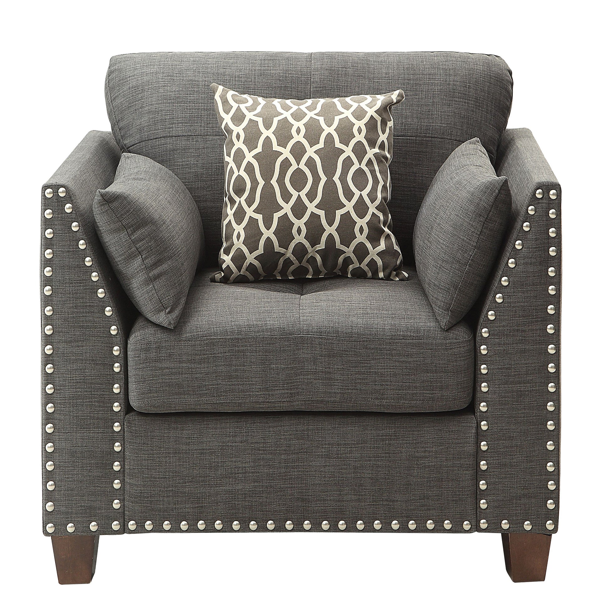 Dark gray fabric accent chair with nailhead trim and patterned throw pillow